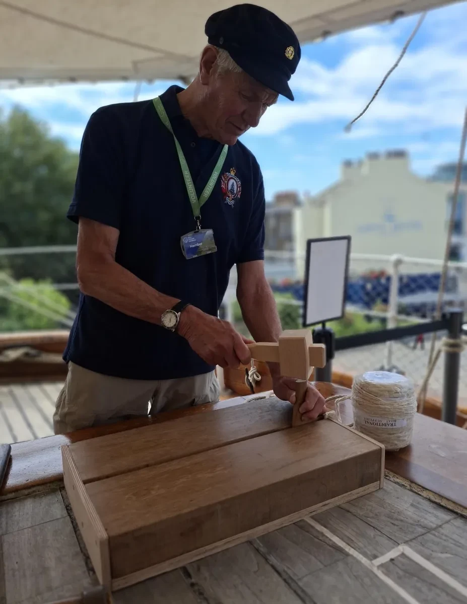 Photo of volunteer caulking on CS deck