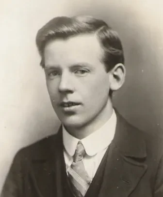 Photo of a young man in black and white, wearing a suit and with short hair