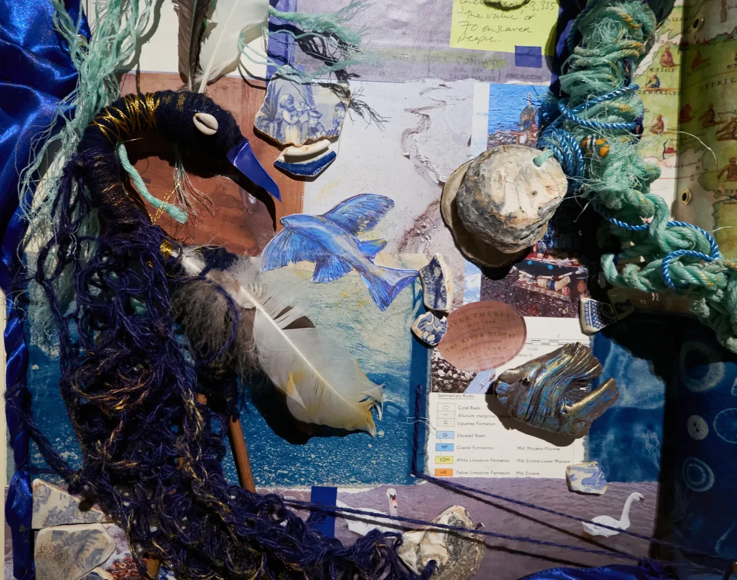 Detail of a dark blue bird within a collage artwork