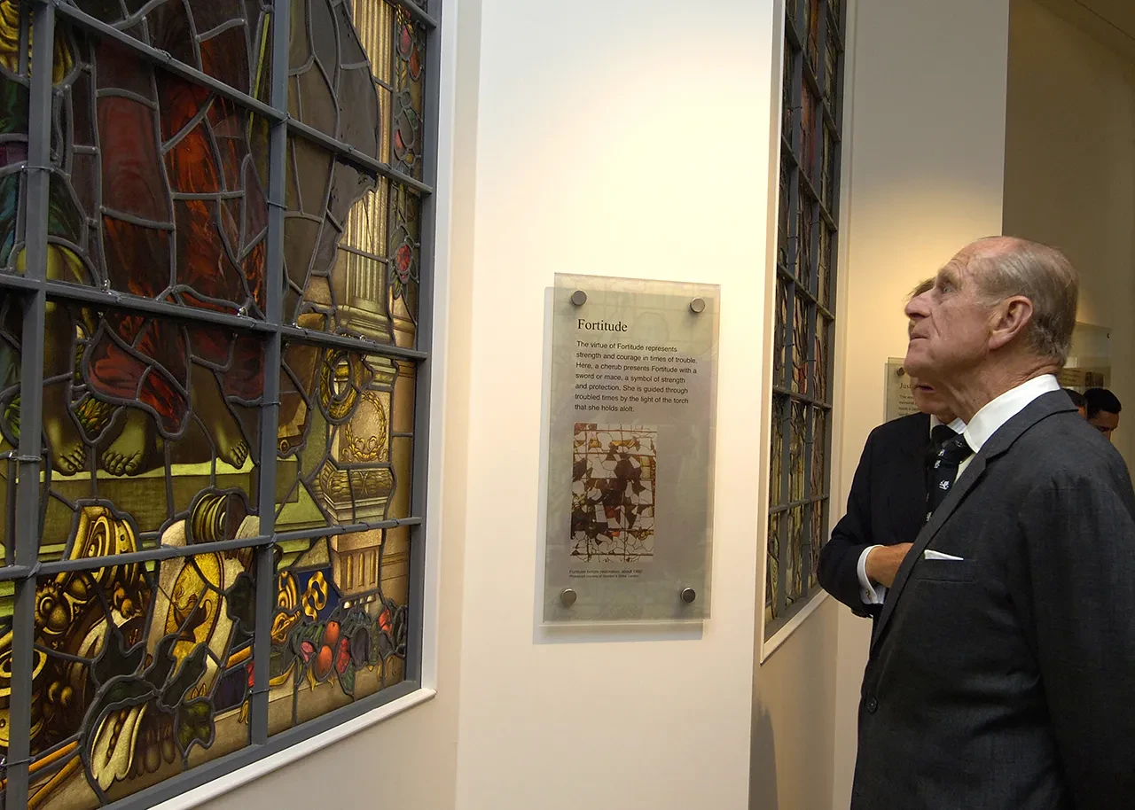 Prince Philip visits the National Maritime Museum and looks at a stained glass window named 'Fortitude'