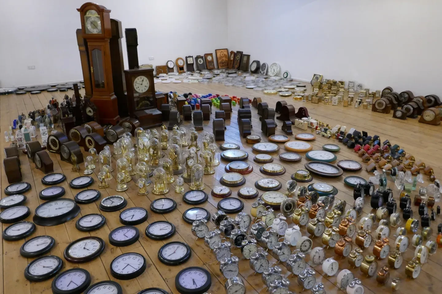 Image showing an array of ticking clocks laid out