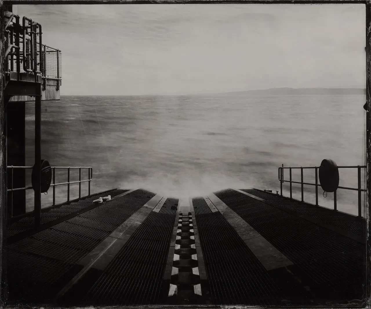 Black and white photography showing the view looking down the slipway of Moelfre RNLI Lifeboat Station