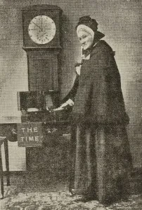Image of Victorian woman next to grandfather clock