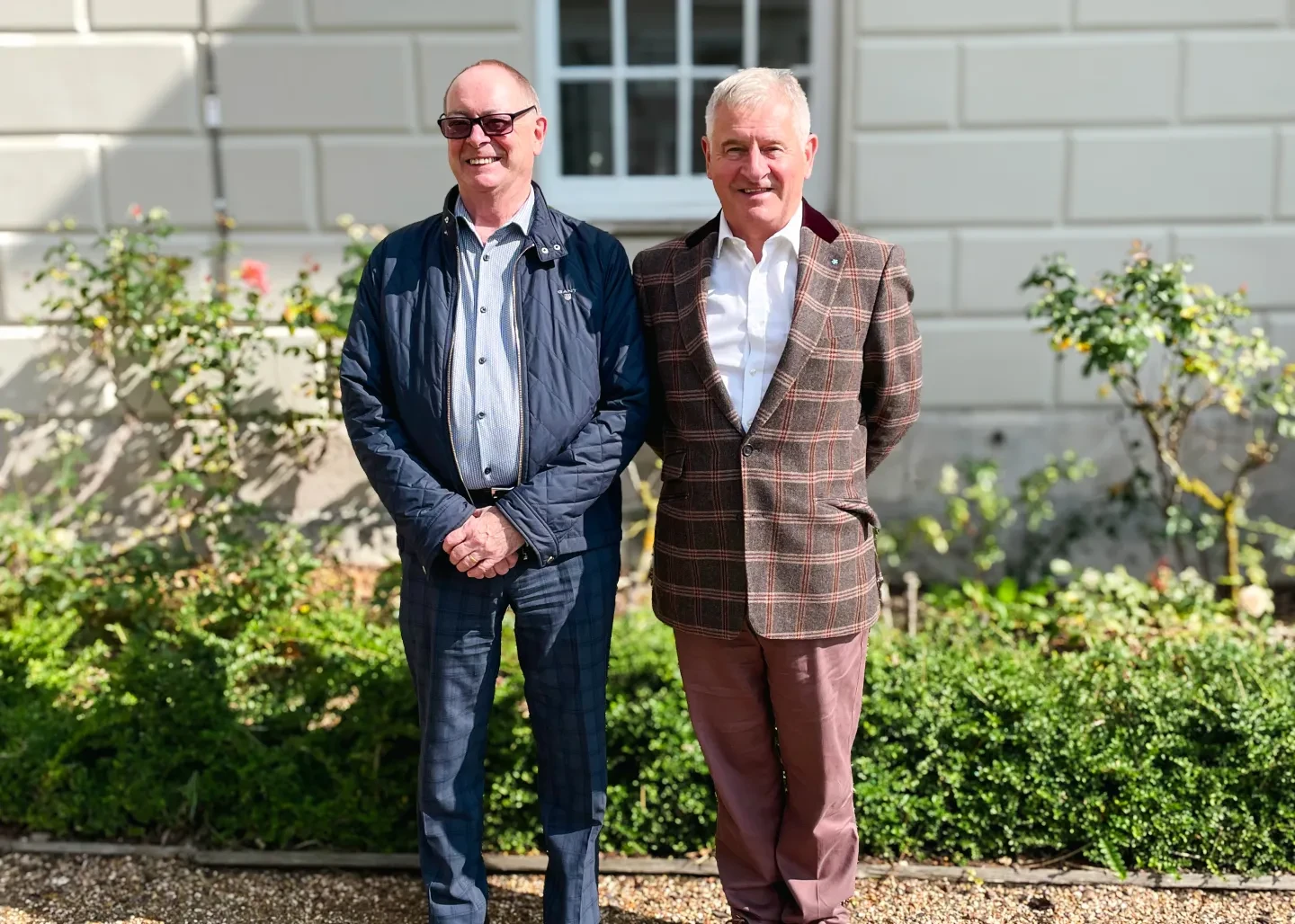 Dominic Brown and Michael Rudder standing together outside a building