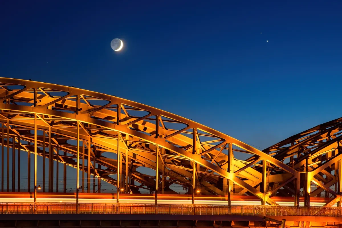 Moon Crescent and Jupiter-Saturn Conjunction over suspension bridge