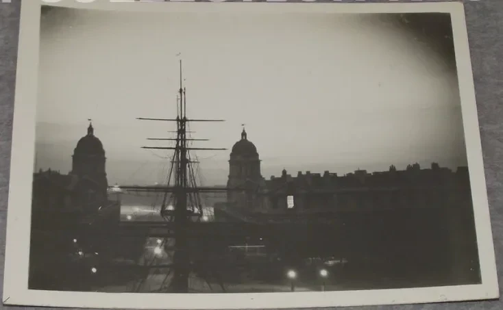 Old photo showing the sky above Greenwich lit with a bright white glow.