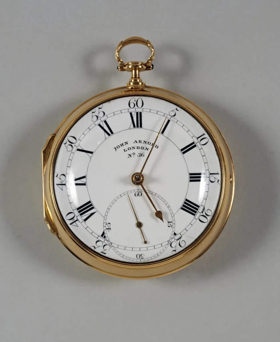 Image of a gold pocket chronometer with crisp lettering and roman numerals