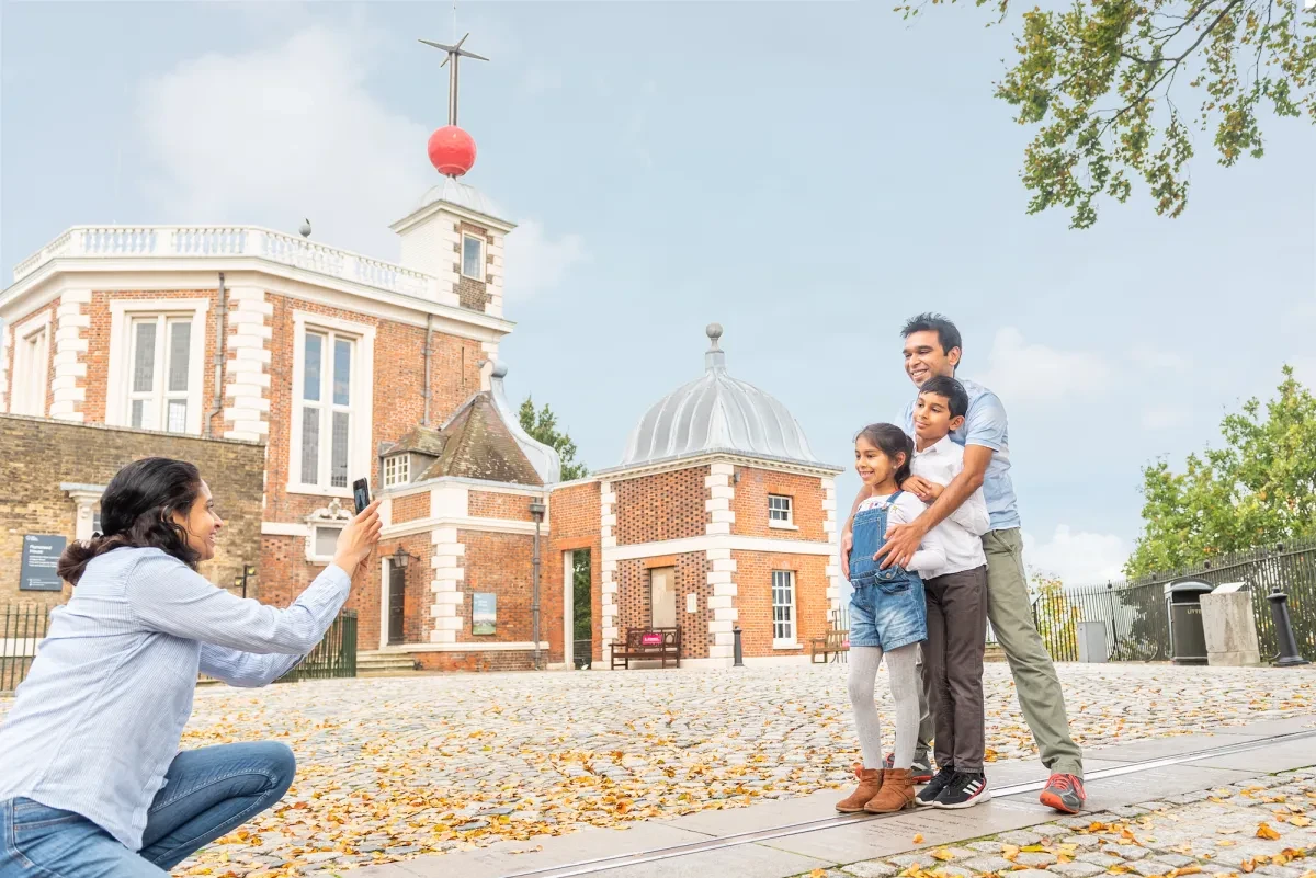 A family poses for photographs on the Prime Meridian Line at the Royal Observatory Greenwich