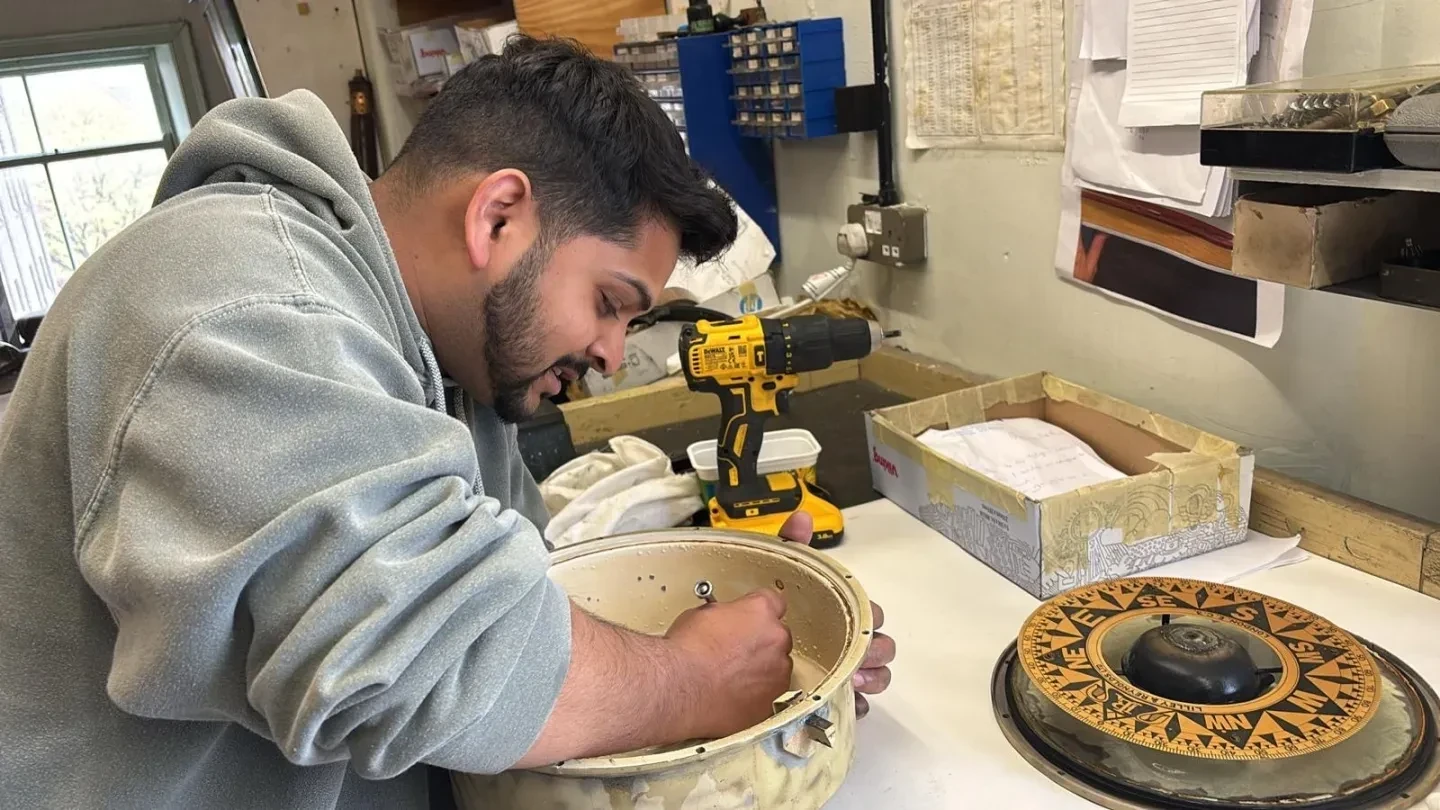 Sylvester Perera works on the compass inside Cutty Sark's new binnacle