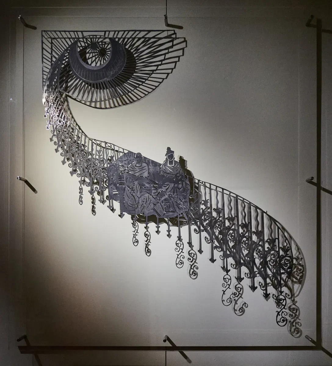 An artwork showing a historic picture of four women against a iron staircase banister